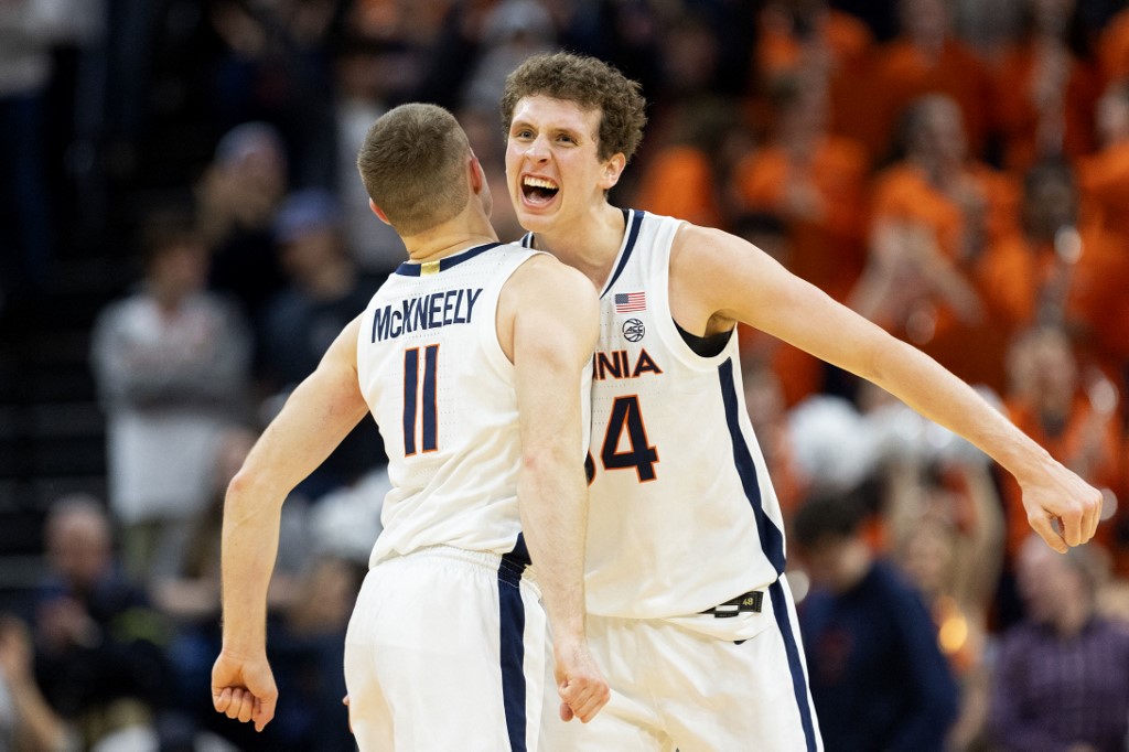 Jake Groves #34 and Isaac McKneely #11 of the Virginia Cavaliers celebrate a shot as we look at the Virginia sports betting handle for December 2023.