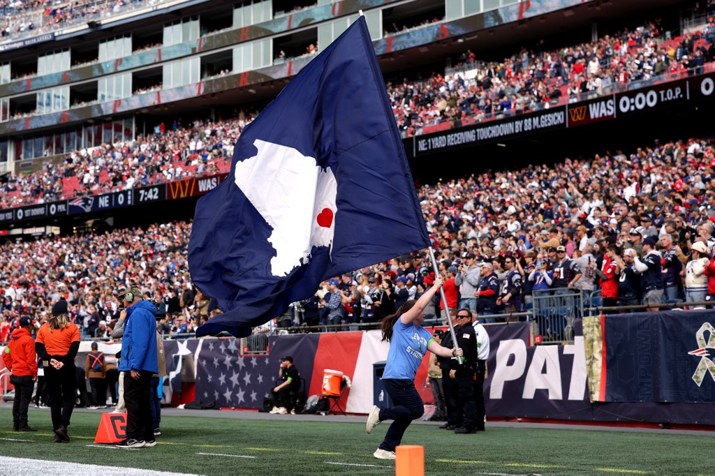 A Lewiston, Maine strong flag is flown prior to the game between the Washington Commanders and the New England Patriots as we look at the Main sports betting report.
