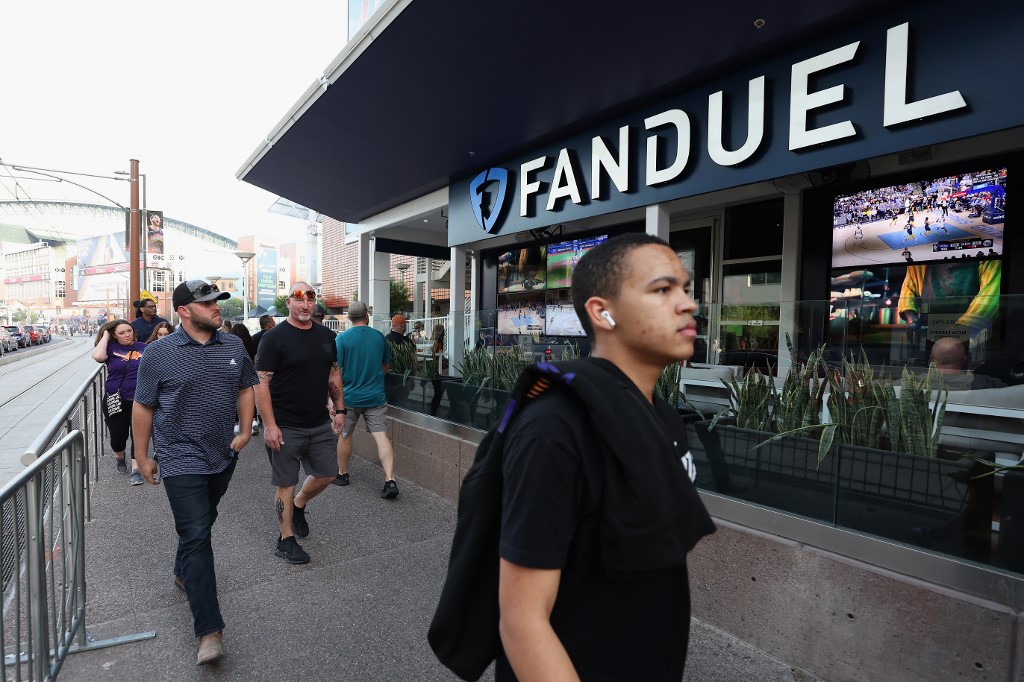 Fans walk past a FanDuel sports betting location. A FanDuel sportsbook In Pennsylvania was the victim of an attempted armed robbery.