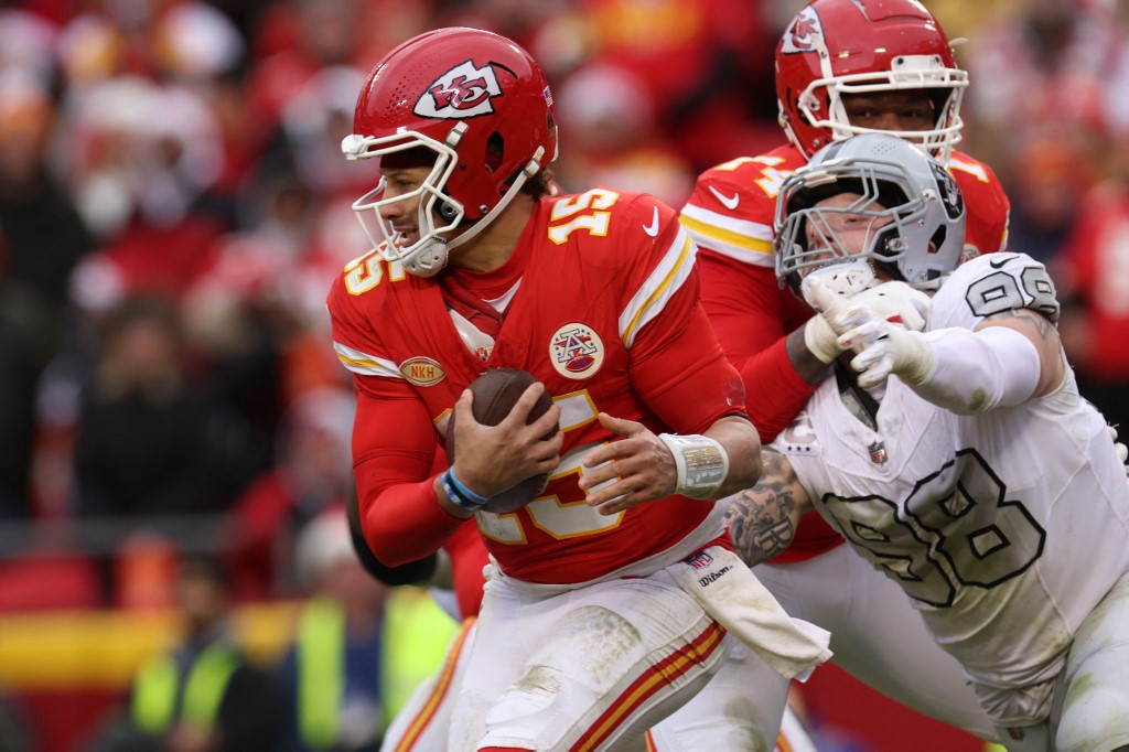 Patrick Mahomes of the Kansas City Chiefs feels the pressure ahead of our Week 17 NFL predictions for Bengals vs. Chiefs