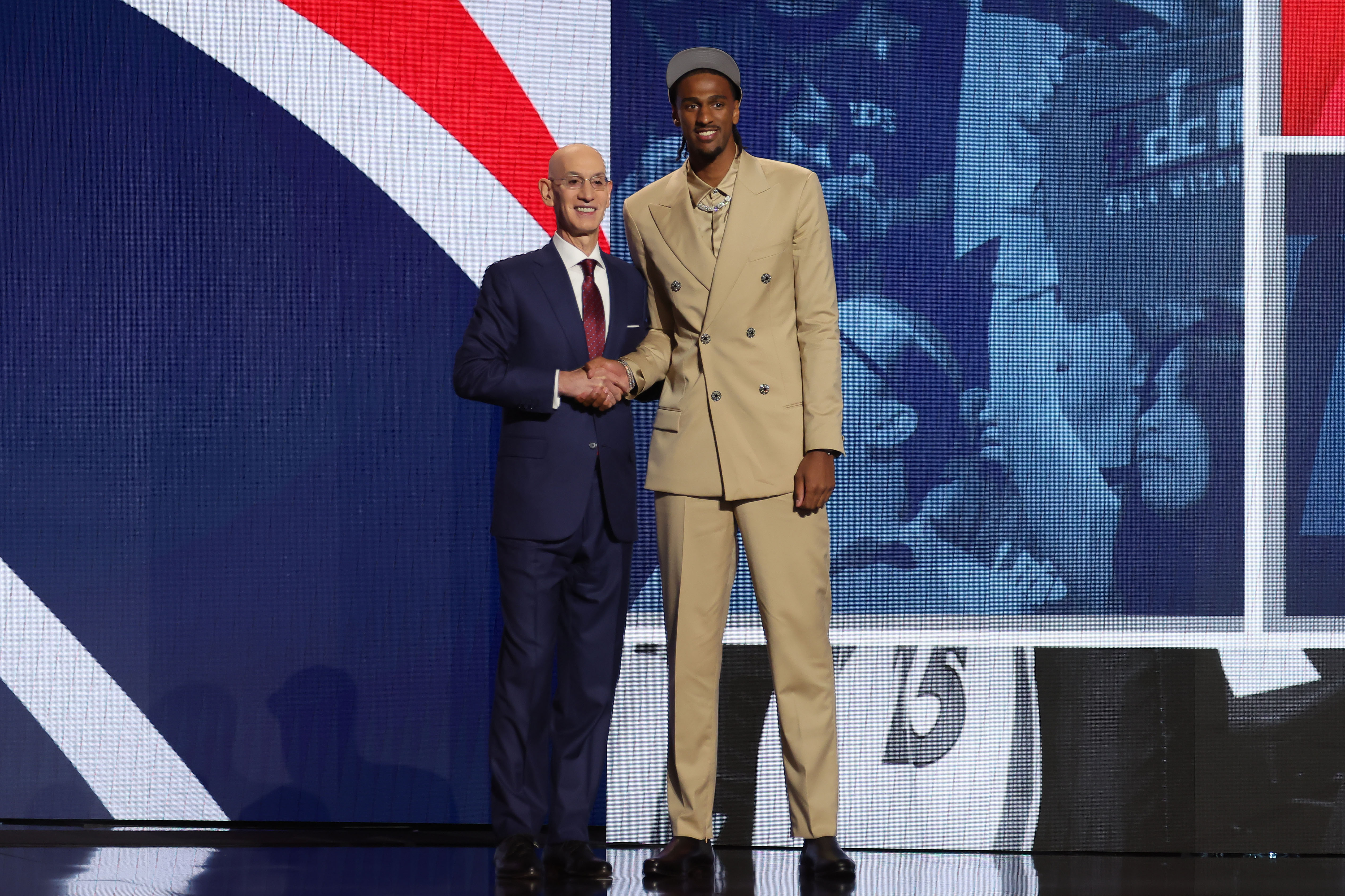 Alexandre Sarr poses for photos with NBA commissioner Adam Silver after being selected in the first round by the Washington Wizards in the 2024 NBA Draft. Sarr leads the NBA Rookie of the Year Odds.