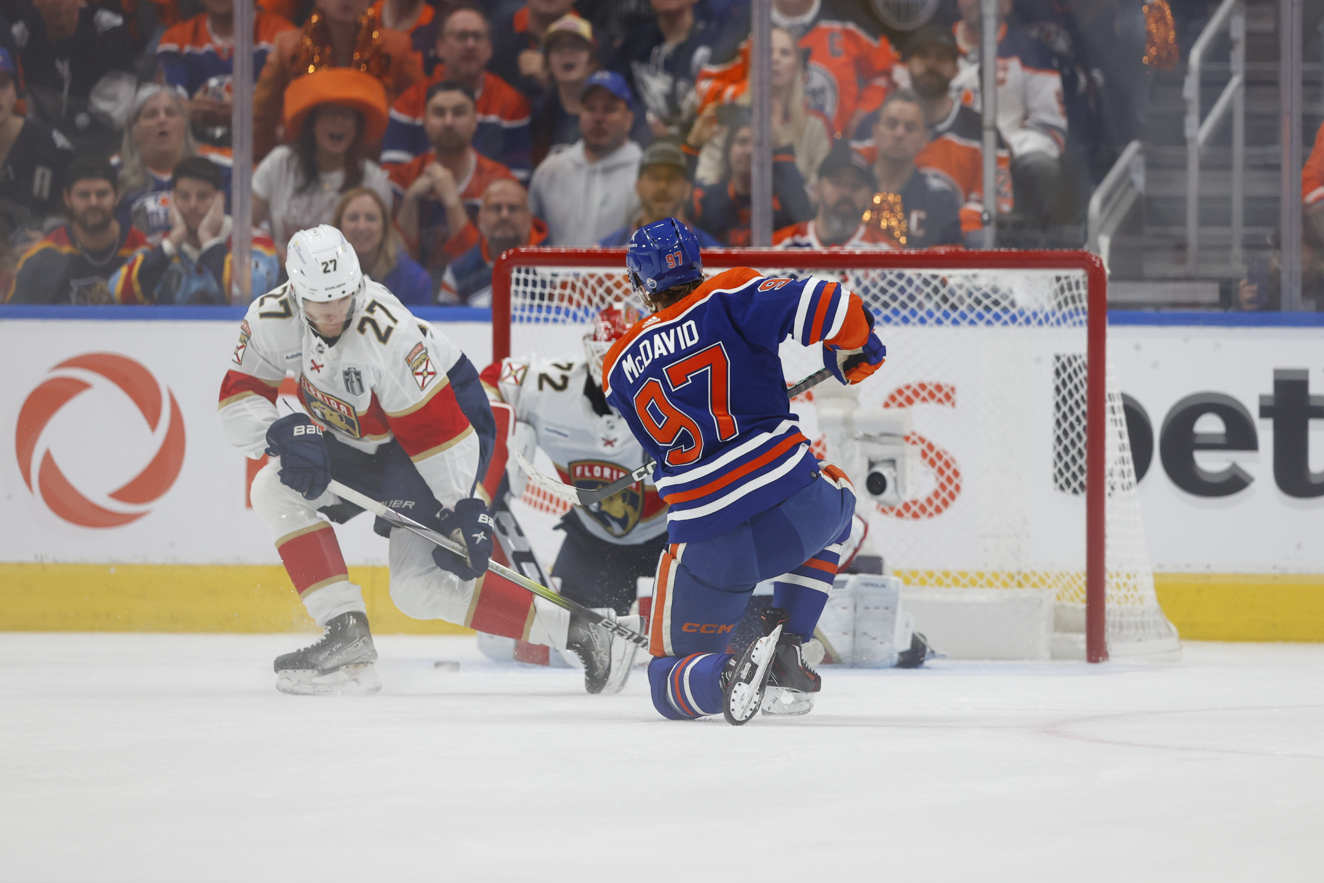 Edmonton Oilers center Connor McDavid shoots the puck defended by Florida Panthers center Eetu Luostarinen as we dive into the best props for Saturday's Game 4 of the Stanley Cup Final between the Panthers and Oilers.