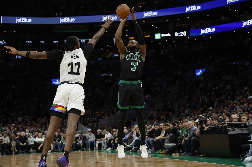 Jaylen Brown of the Boston Celtics shoots over Naz Reid of the Minnesota Timberwolves during the second half at TD Garden on December 23, 2022 in Boston, Massachusetts.