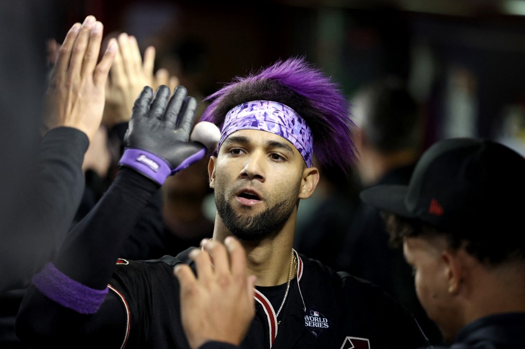 Lourdes Gurriel Jr. of the Arizona Diamondbacks celebrates with teammates after hitting a home run in the eighth inning against the Texas Rangers during Game 4 of the World Series as we look at the December report for Arizona.