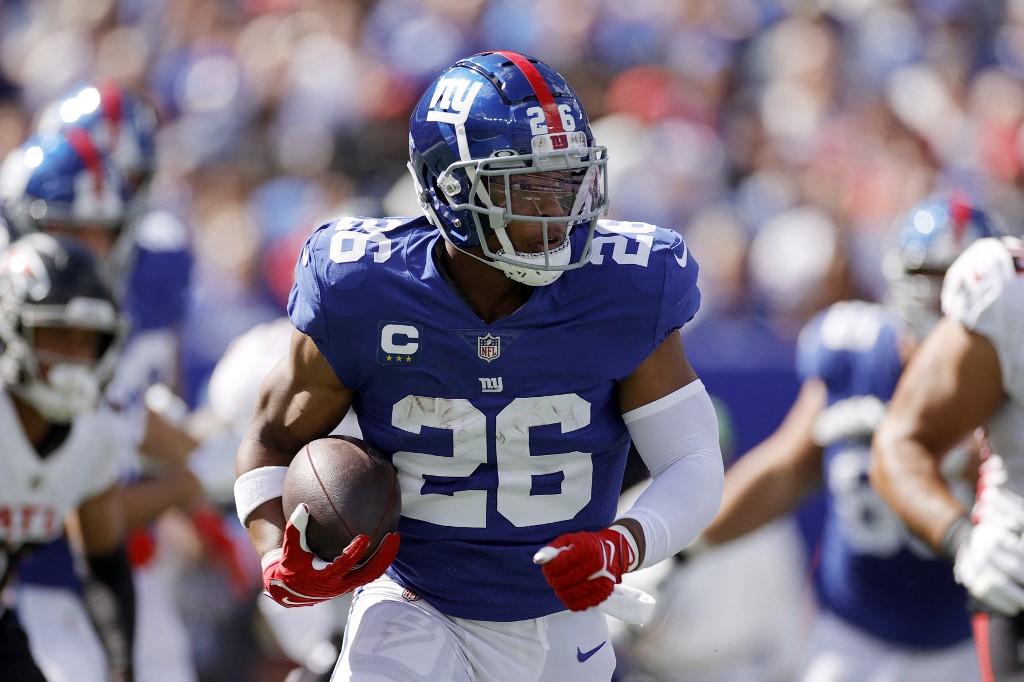 Saquon Barkley of the New York Giants carries the ball against the Atlanta Falcons at MetLife Stadium on Sept. 26, 2021 in East Rutherford, New Jersey.