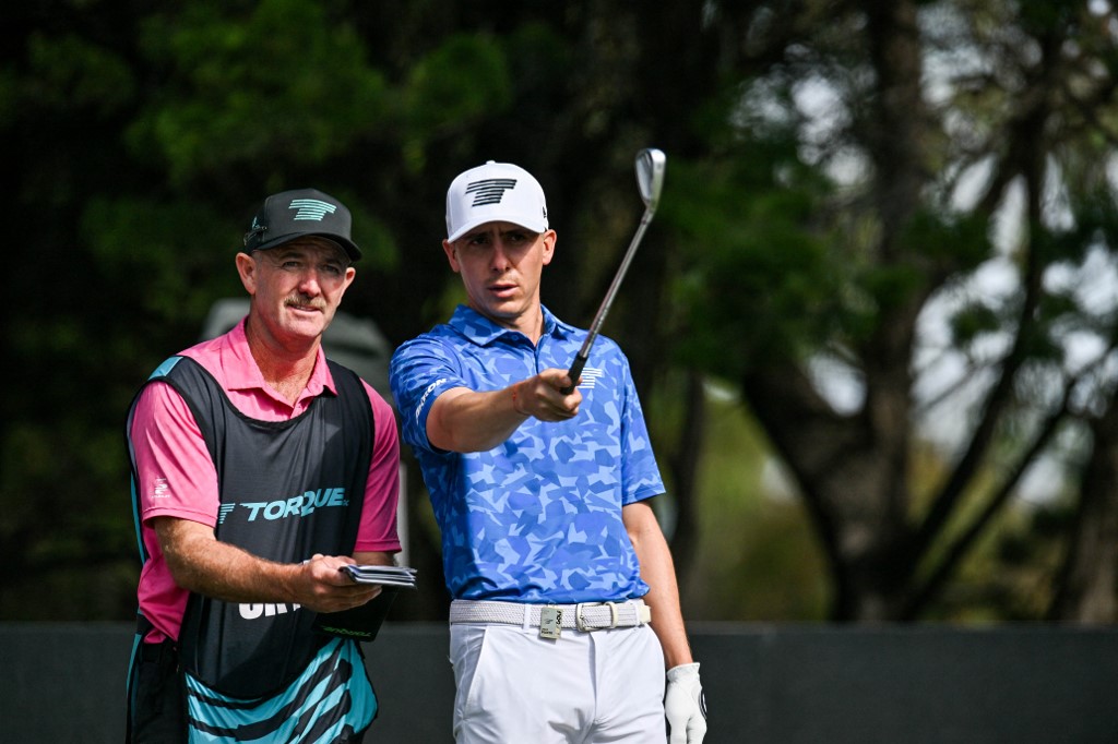 Chile's Joaquin Niemann (R) talks to his caddy as we look at our PGA Championship picks.
