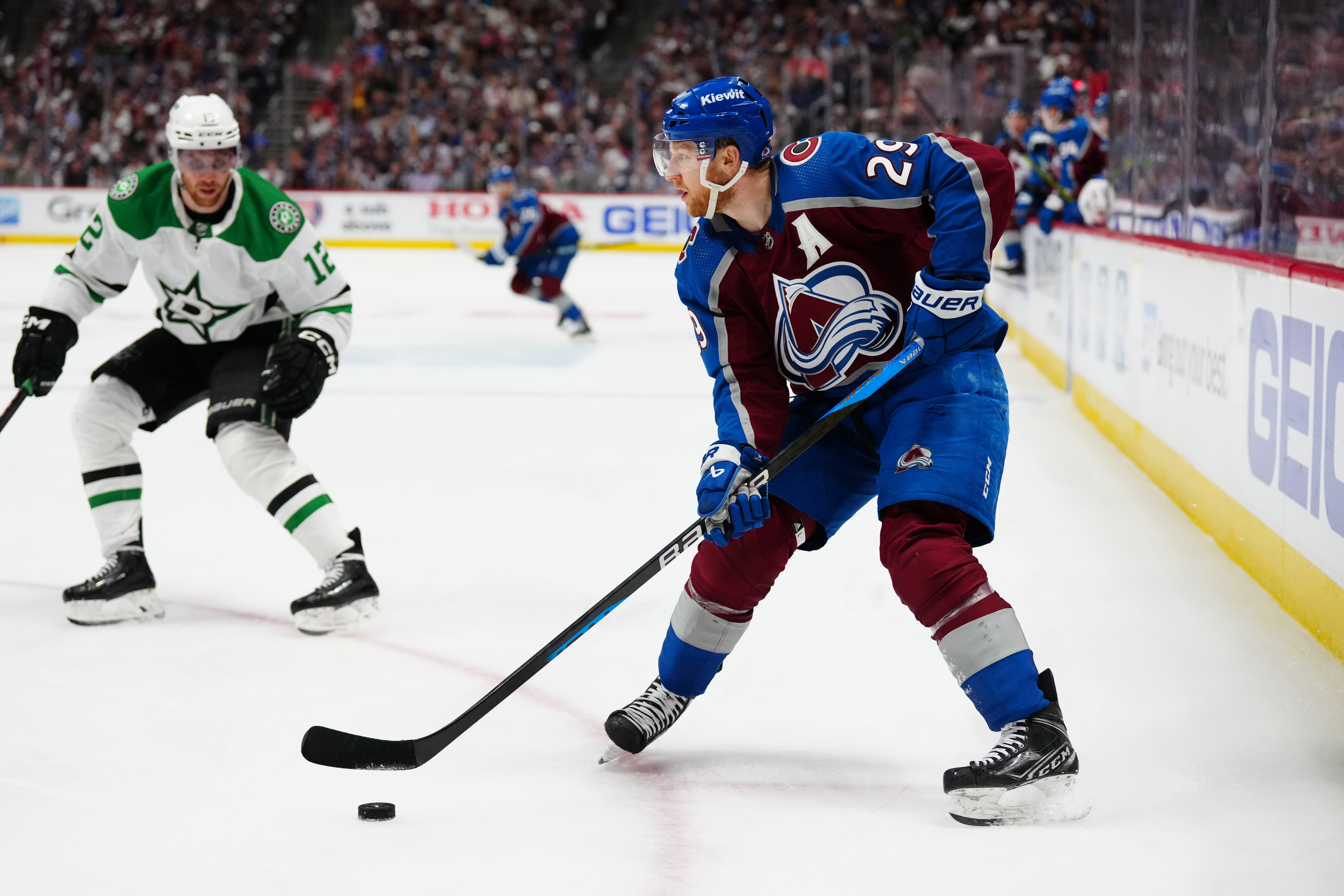 Colorado Avalanche center Nathan MacKinnon controls the puck in overtime against the Dallas Stars as we dive into our 2024-25 NHL award predictions for the Hart, Vezina, and Norris Trophies.