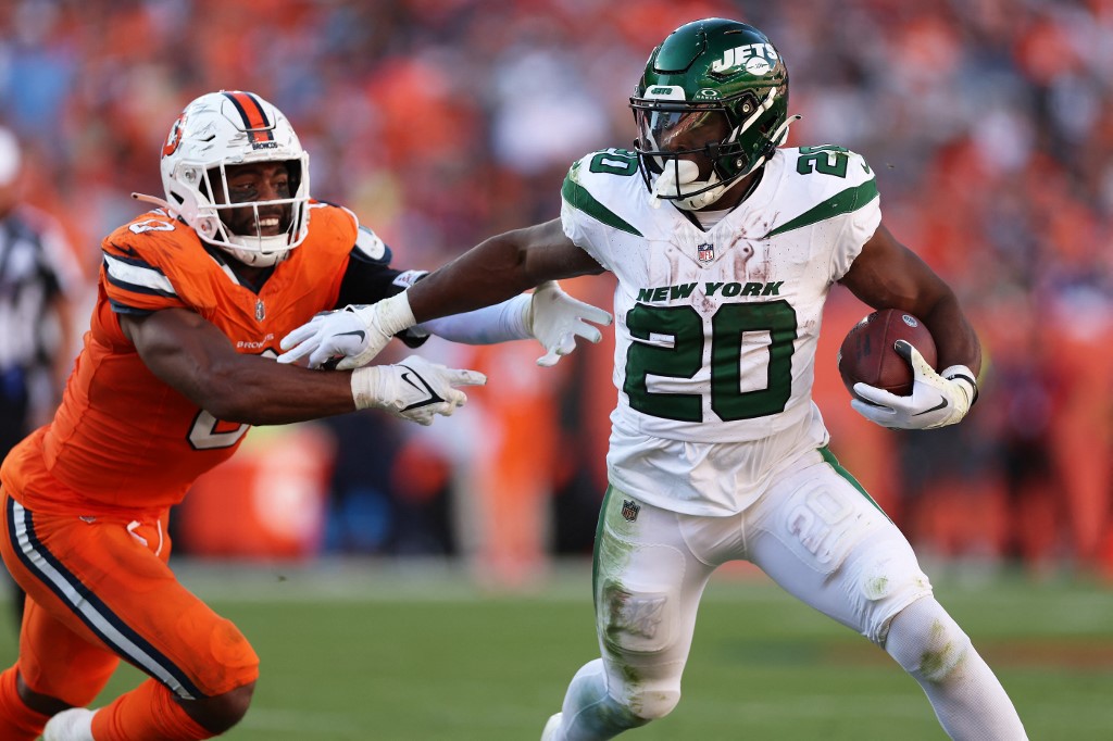Breece Hall of the New York Jets runs with the ball while being chased by Jonathon Cooper #0 of the Denver Broncos as we look at our NFL prop picks for Week 9.