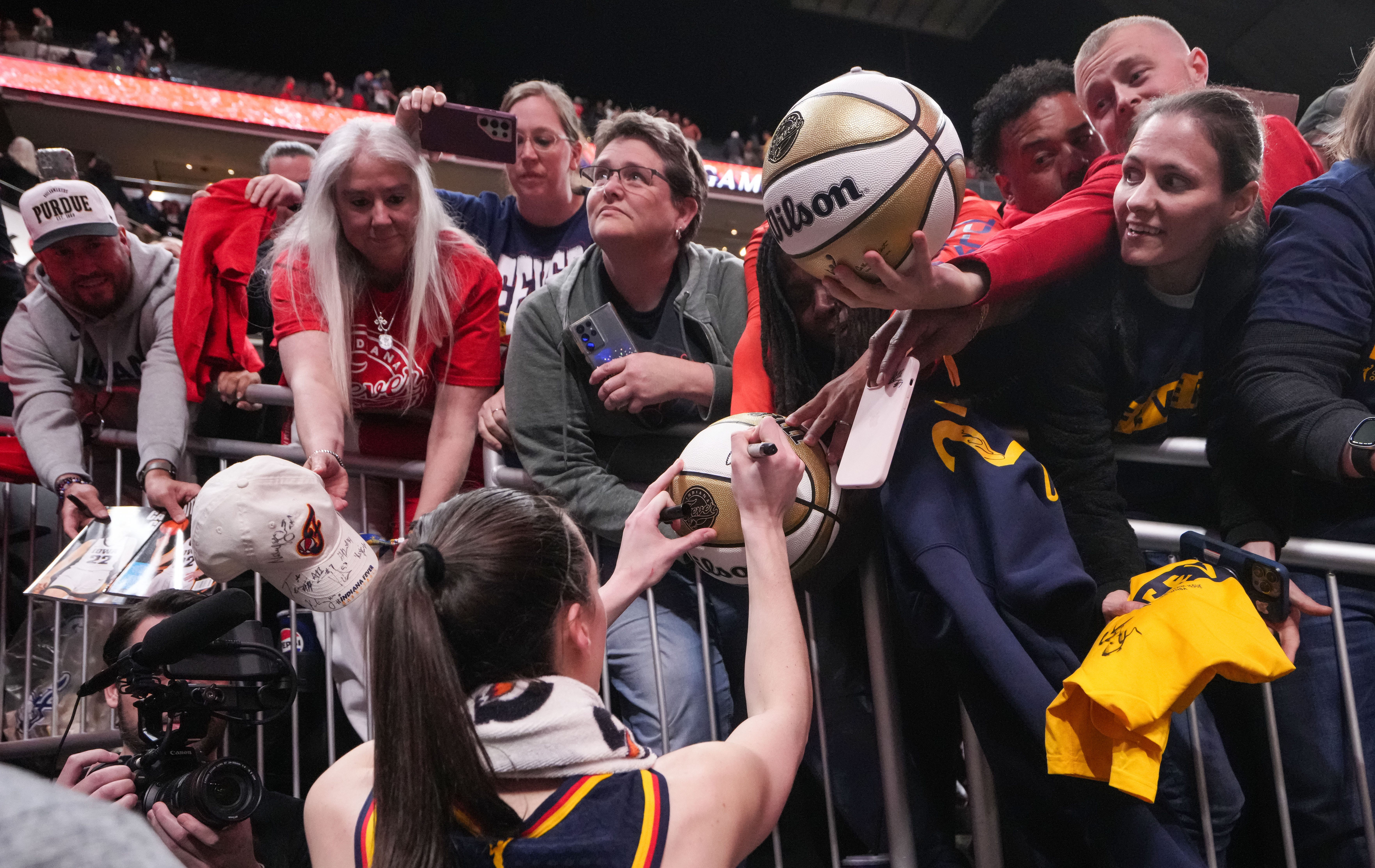 Indiana Fever guard Caitlin Clark (22) signs autographs for fans as we look at the Indiana sports betting revenue report for May.