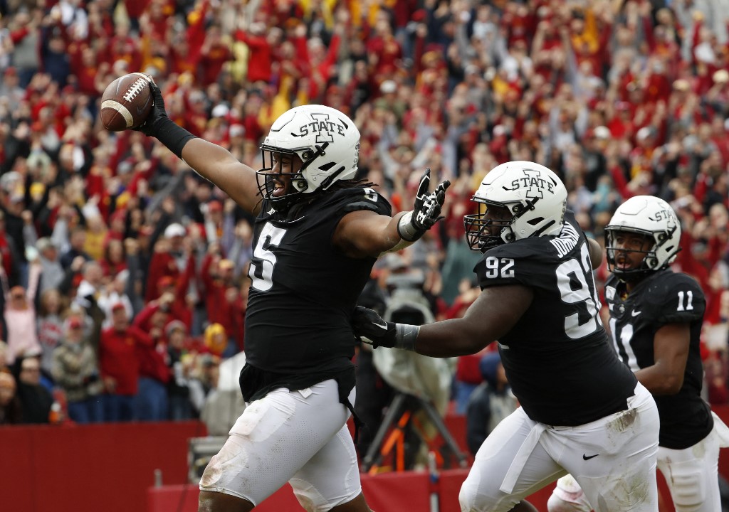 Defensive end Eyioma Uwazurike #5 of the Iowa State Cyclones celebrates as we look at the details of the dropped sports betting charges against four former Iowa State athletes.