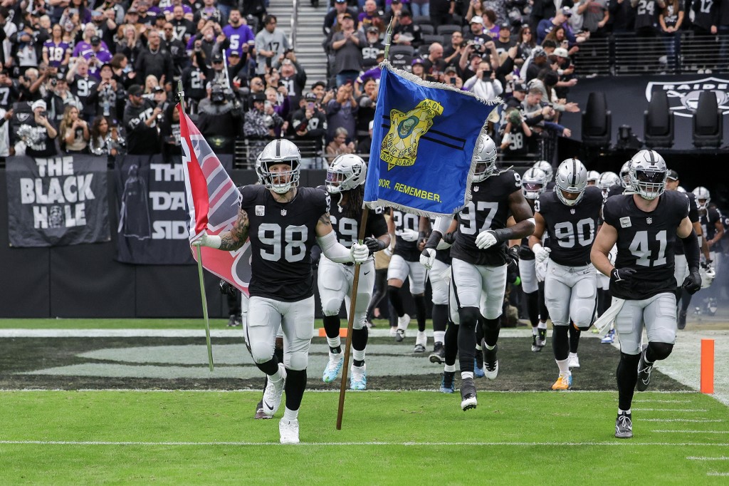 Defensive end Maxx Crosby #98 of the Las Vegas Raiders carries a UNLV flag as we look at our Chargers vs. Raiders prediction for TNF