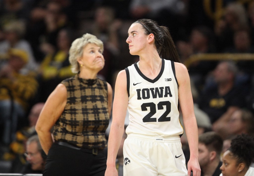 Guard Caitlin Clark #22 of the Iowa Hawkeyes and head coach Lisa Bluder react as we look at Fanatics launching in Iowa