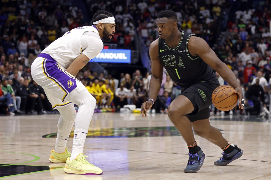 Zion Williamson of the New Orleans Pelicans is defended by Anthony Davis of the Los Angeles Lakers during a game at Smoothie King Center. We're backing Williamson in our NBA player props and best bets for Tuesday.