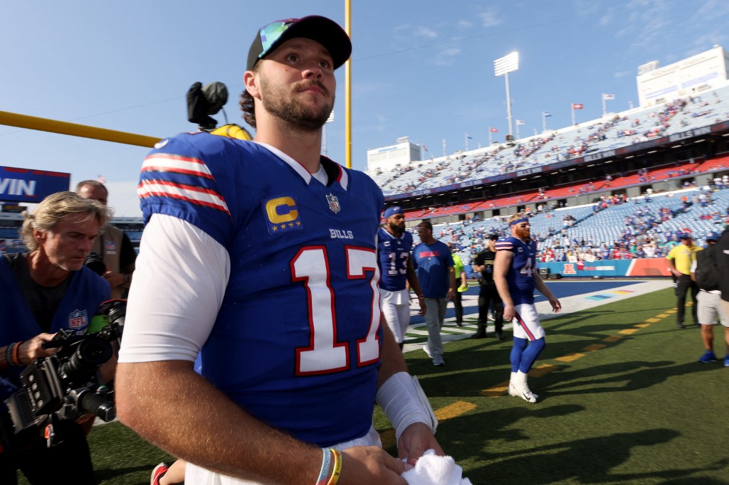 Josh Allen of the Buffalo Bills walks off the field after defeating the Miami Dolphins, and we offer new U.S. bettors our exclusive Caesars promo code.