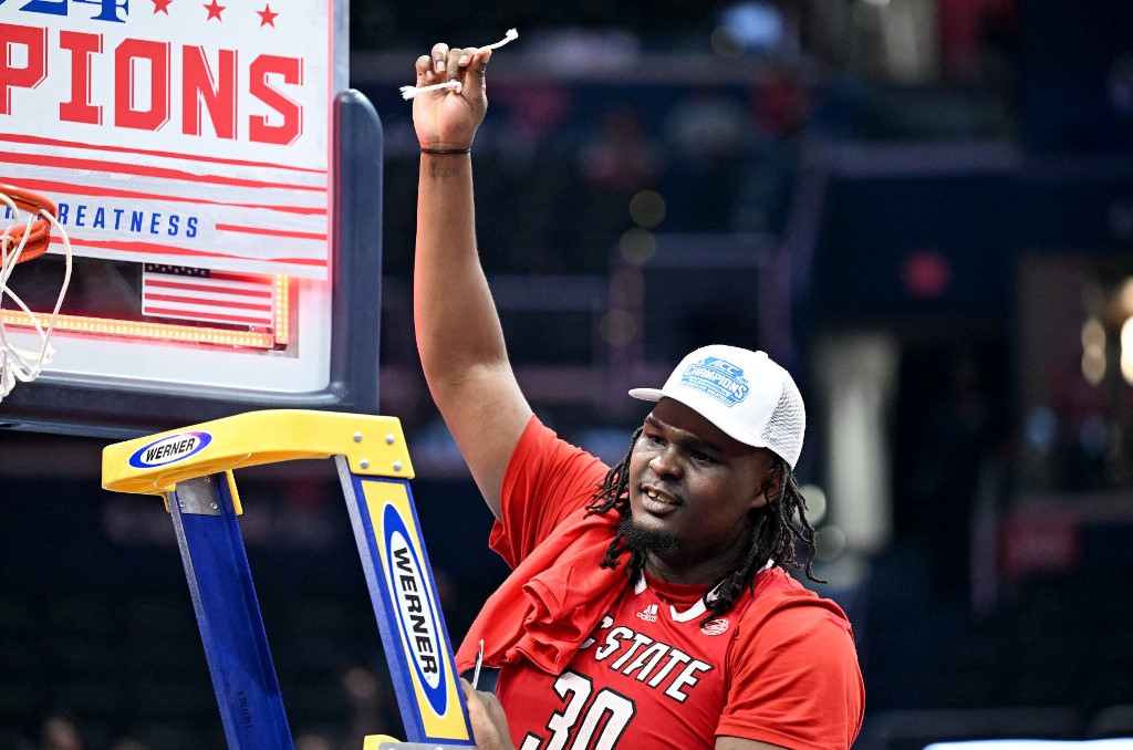 DJ Burns Jr. #30 of the North Carolina State Wolfpack cuts down the net as we look at our bet365 North Carolina bonus code