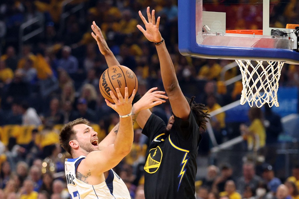 Luka Doncic of the Dallas Mavericks drives to the basket against Kevon Looney of the Golden State Warriors in Game Five of the 2022 NBA Playoffs Western Conference Finals at Chase Center on May 26, 2022 in San Francisco, California