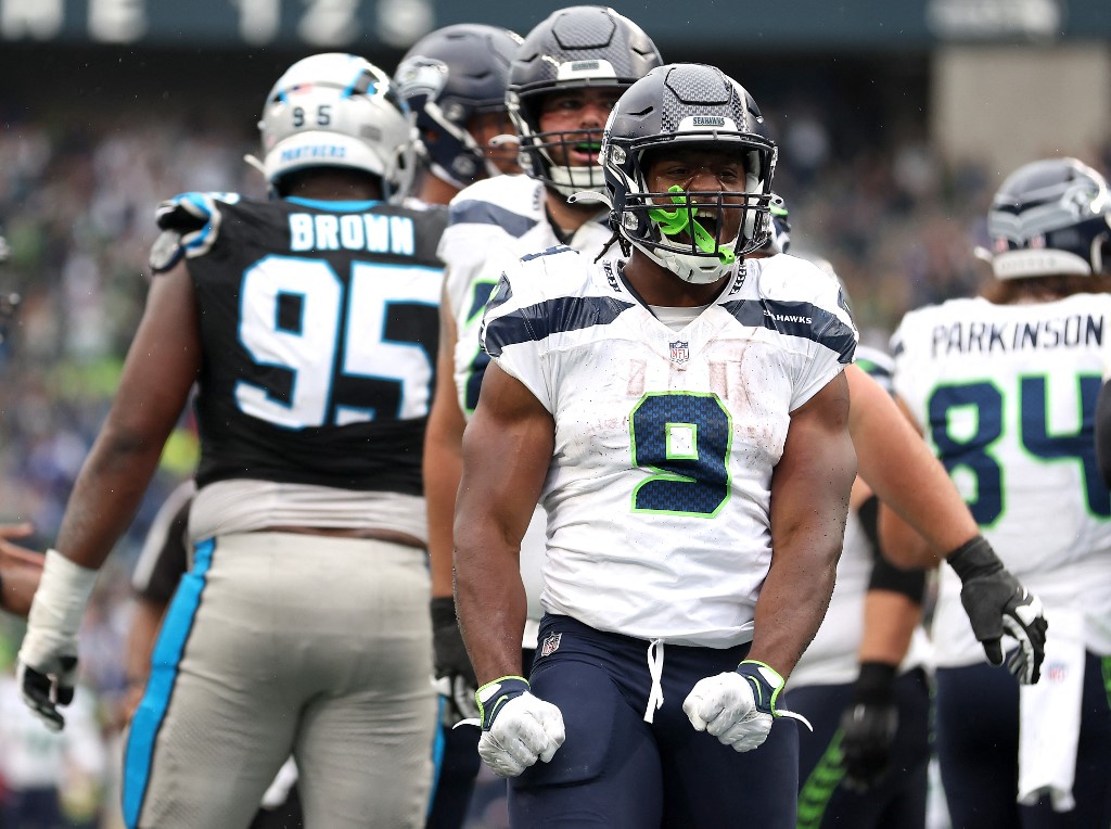 Kenneth Walker III of the Seattle Seahawks celebrates after scoring a rushing touchdown during the third quarter against the Carolina Panthers, and we offer our top SGP predictions for MNF based on the best NFL odds.
