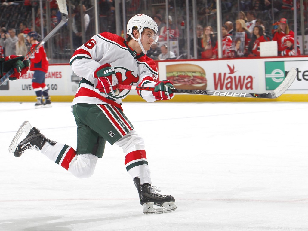 New Jersey Devils center Jack Hughes fires a shot in warm-ups before a game against the Washington Capitals.