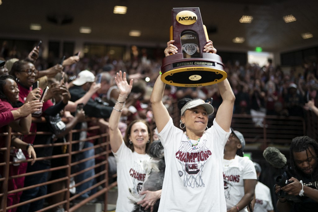 South Carolina coach Dawn Staley raises the NCAA Women's Basketball Championship trophy at a celebration at the Colonial Life Arena in Columbia, South Carolina. South Carolina opened as the favorite to repeat by the 2025 women's March Madness odds.