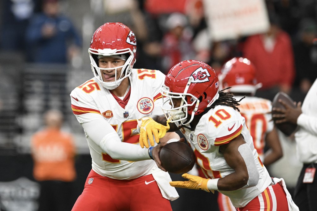 Quarterback Patrick Mahomes #15 hands the ball off to running back Isiah Pacheco as we make our Chiefs vs. Packers prediction for SNF