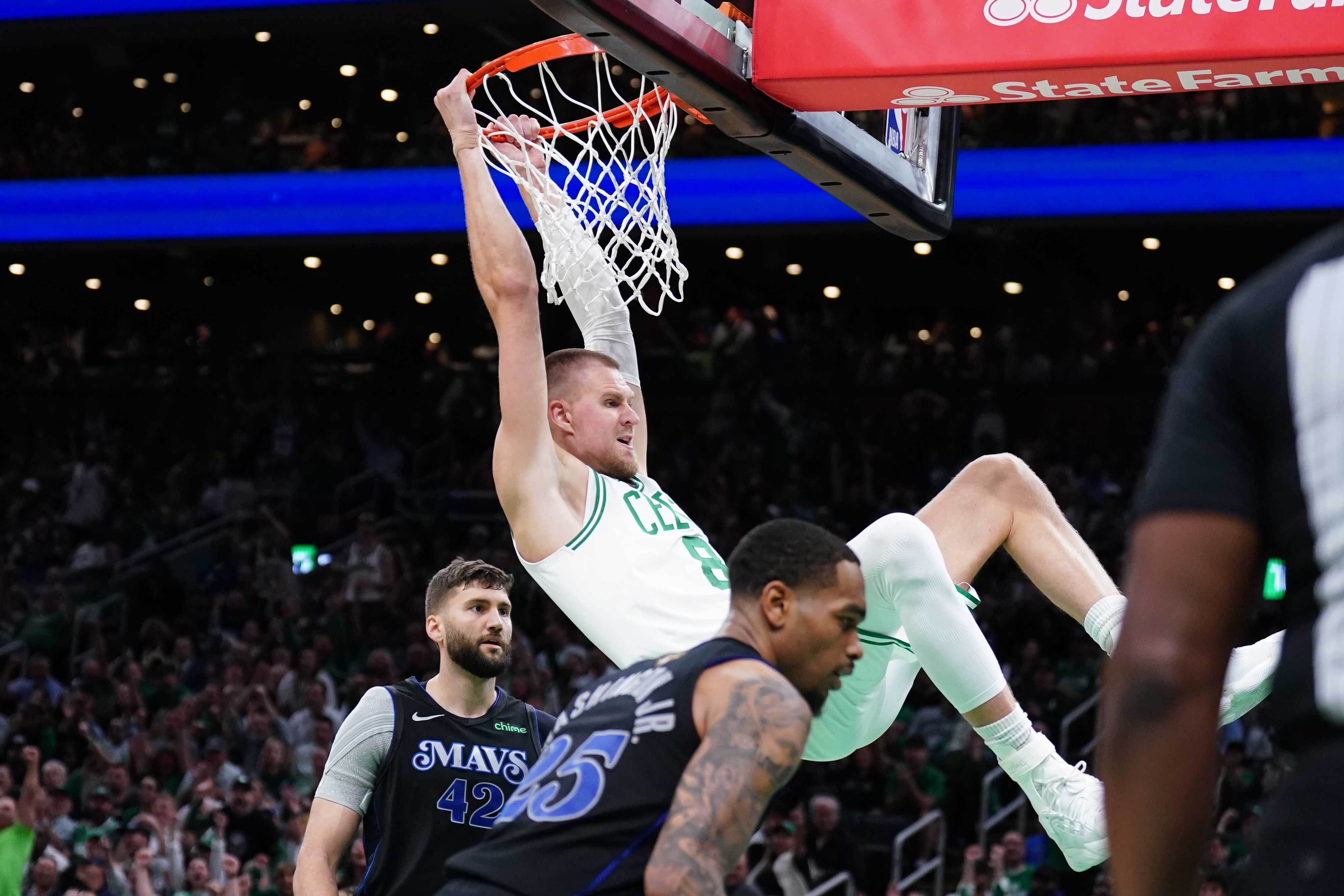Boston Celtics center Kristaps Porzingis dunks against Dallas Mavericks forward P.J. Washington and forward Maxi Kleber as we dive into the best player props for Sunday's Game 2 of the NBA Finals.