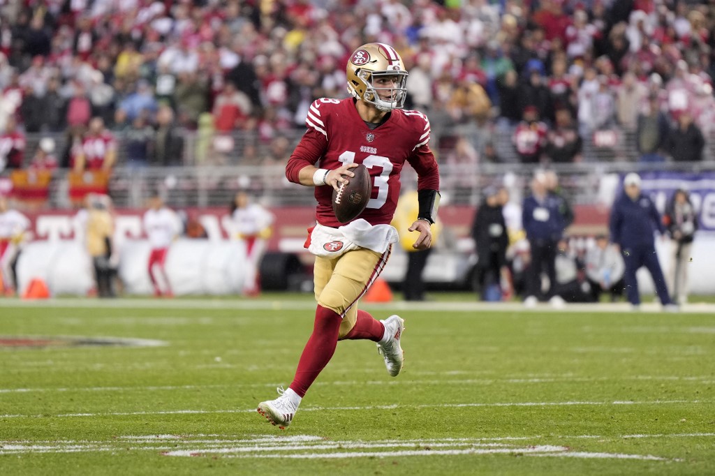 Brock Purdy of the San Francisco 49ers scrambles against the Seattle Seahawks in the NFC Wild Card playoff game at Levi's Stadium in Santa Clara, California. Photo by Thearon W. Henderson/Getty Images via AFP.  
