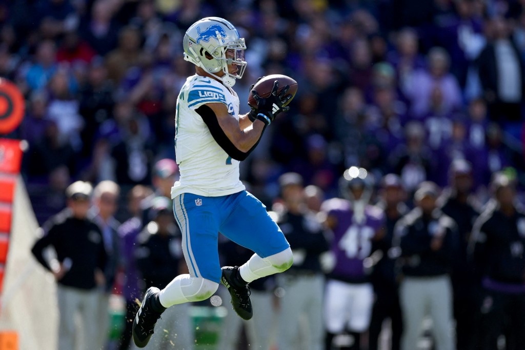 Amon-Ra St. Brown #14 of the Detroit Lions catches a pass as we look at our Raiders vs. Lions Monday Night Football player props