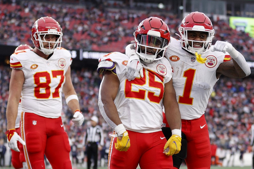 Travis Kelce #87, Clyde Edwards-Helaire #25, and Jerick McKinnon #1 of the Kansas City Chiefs celebrate as we look at our anytime touchdown scorer predictions for the 2024 Super Bowl.