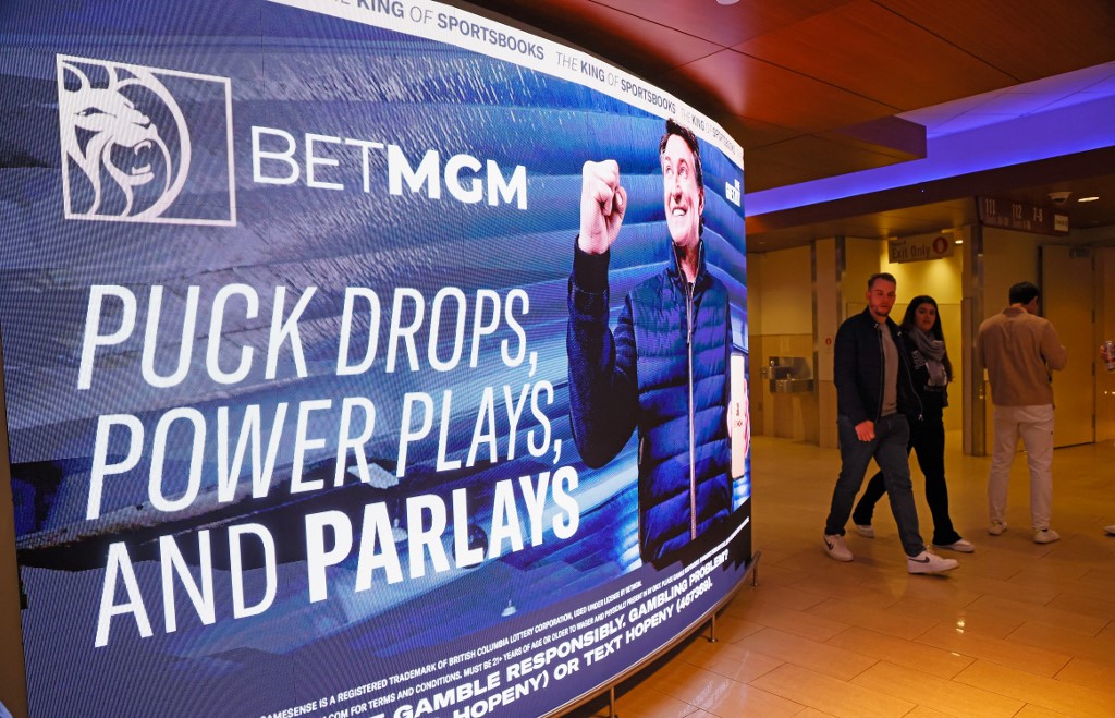Fans walk past BetMGM signage featuring Wayne Gretzky as we look at a report outlining the black market operators in New York, New Jersey, and Minnesota.