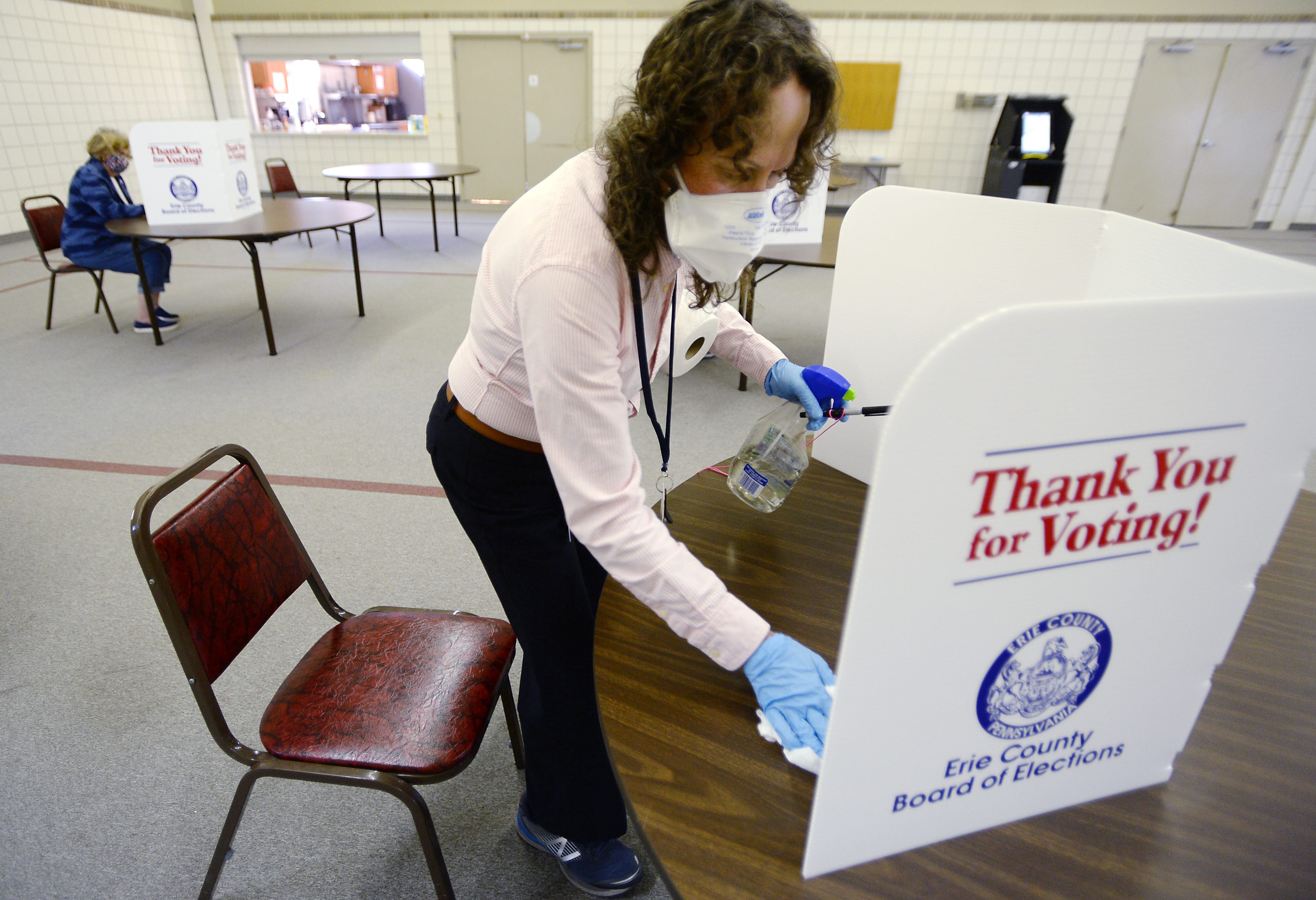 Barb Skonieczki, judge of elections for the 5th Ward, 14th District polling site, sanitizes a booth set up for voters at Trinity United Methodist Church on June 2, 2020, in Erie. 