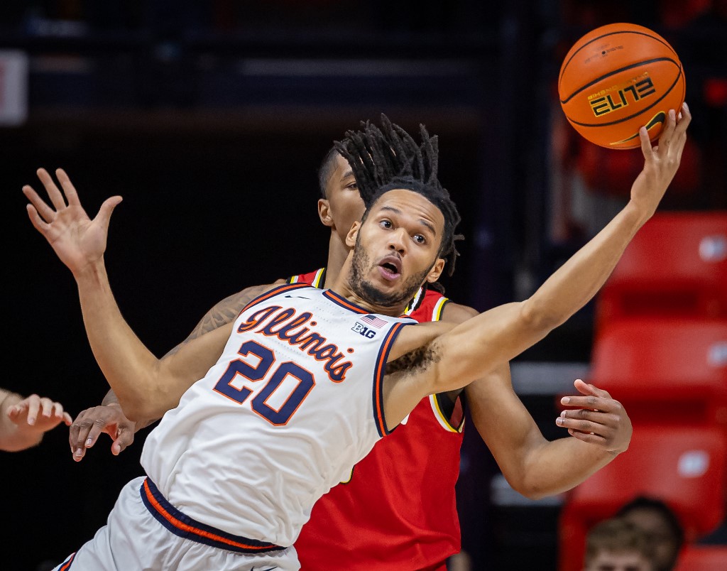 Ty Rodgers #20 of the Illinois Fighting Illini reaches for the rebound as we look at the Illinois sports betting financials from November 2023.
