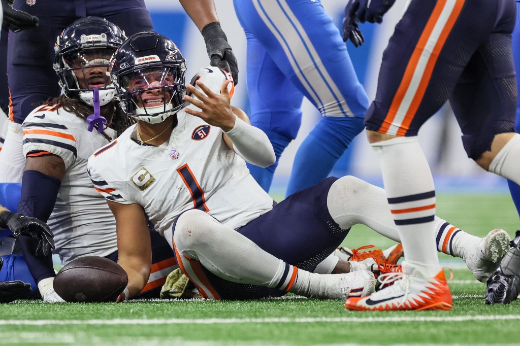 Chicago Bears quarterback Justin Fields (1) reacts after being sacked as we round up our NFL predictions for Week 12