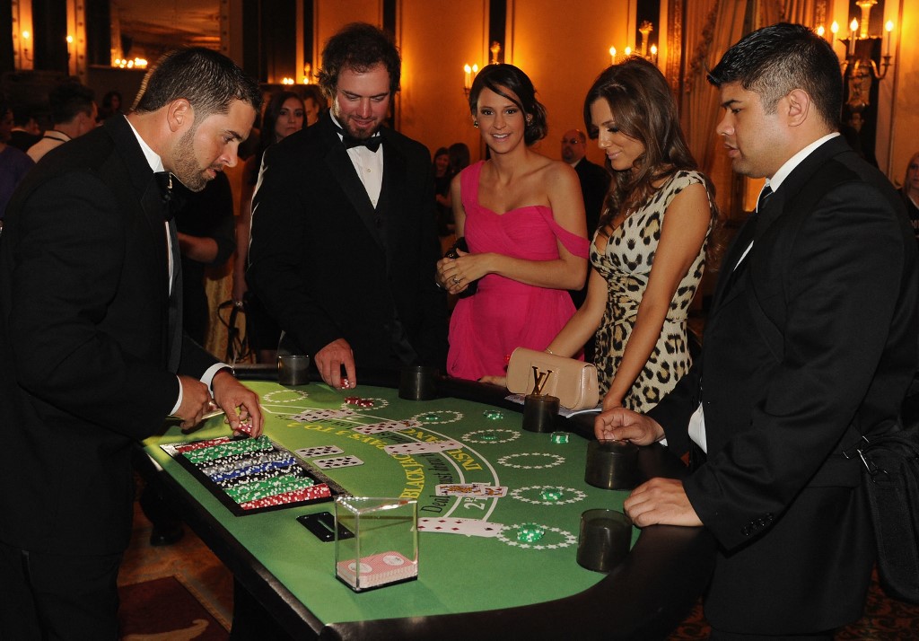 Chicago Cubs David DeJesus deals Blackjack during the 2012 Dempster Foundation casino night as we look at the deal between Caesars and the NFL for Caesars Football Blackjack.