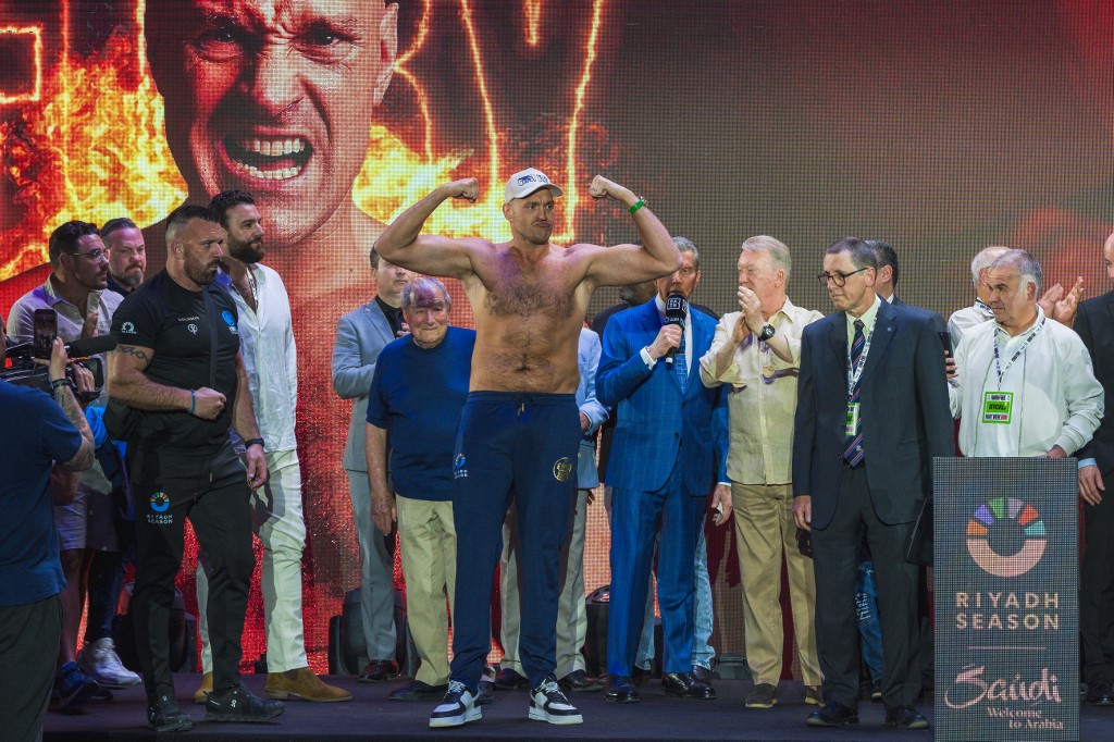 Britain's Tyson Fury gestures on stage during the official weigh-in on the eve of his heavyweight world boxing championship fight against Ukraine's Oleksandr Usyk in Riyadh. We're breaking down our Fury vs. Usyk Predictions.