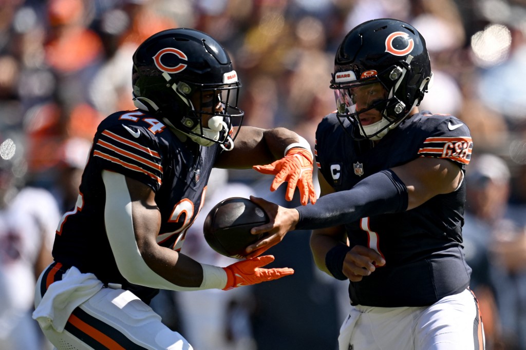 Justin Fields #1 hands the ball off to Khalil Herbert #24 of the Chicago Bears as we look at our Bears - Vikings parlay for Monday Night Football