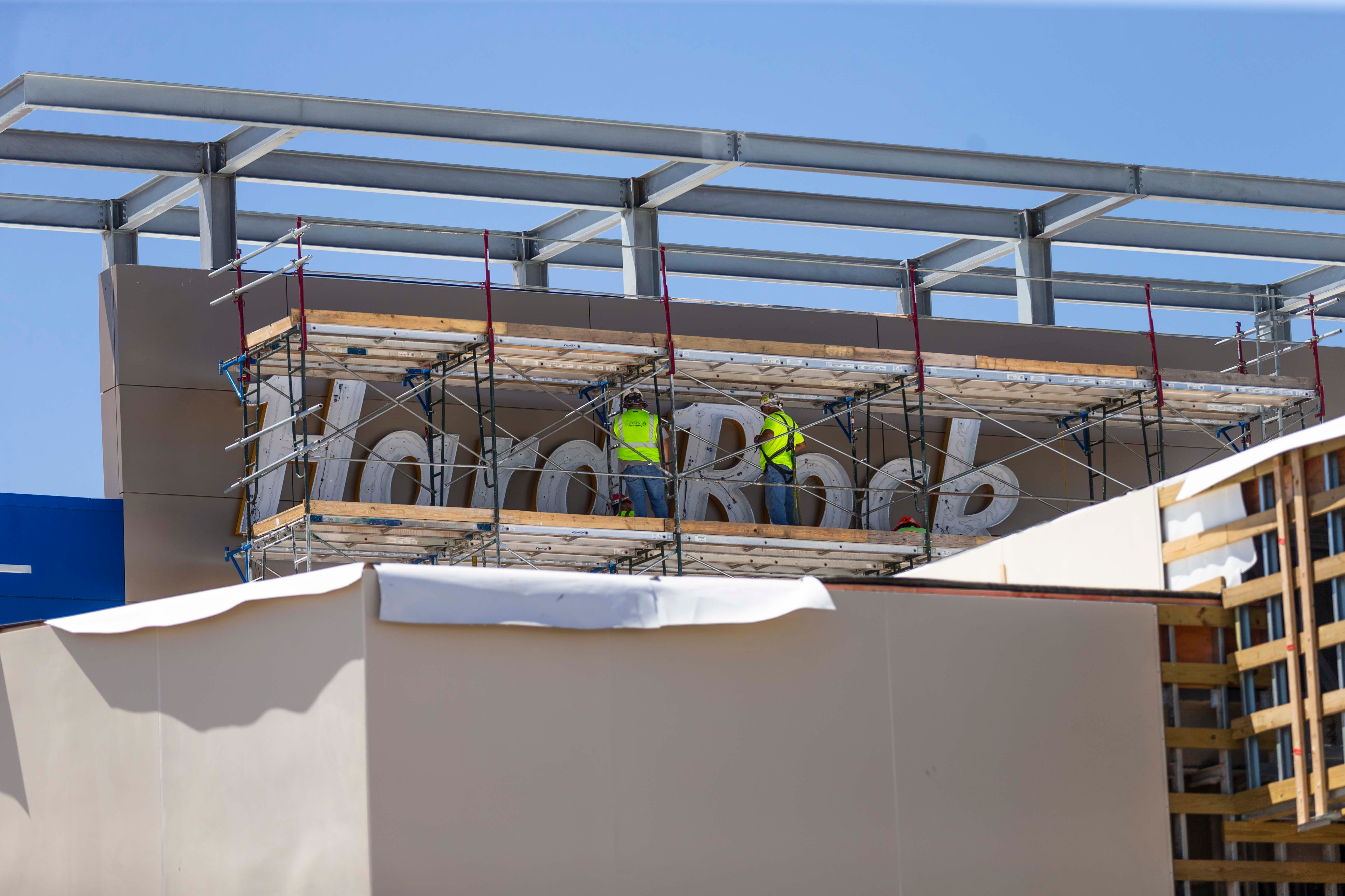 Construction workers build the Hard Rock Casino sign as we look at a new date for licensing casinos in downstate New York.