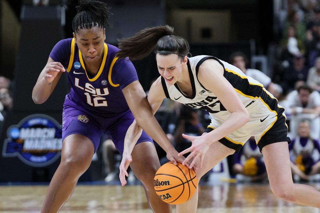 Mikaylah Williams #12 of the LSU Tigers and Caitlin Clark #22 of the Iowa Hawkeyes fight for the ball as we look at the details surrounding how sportsbooks benefitted from the Iowa-LSU Elite Eight game.