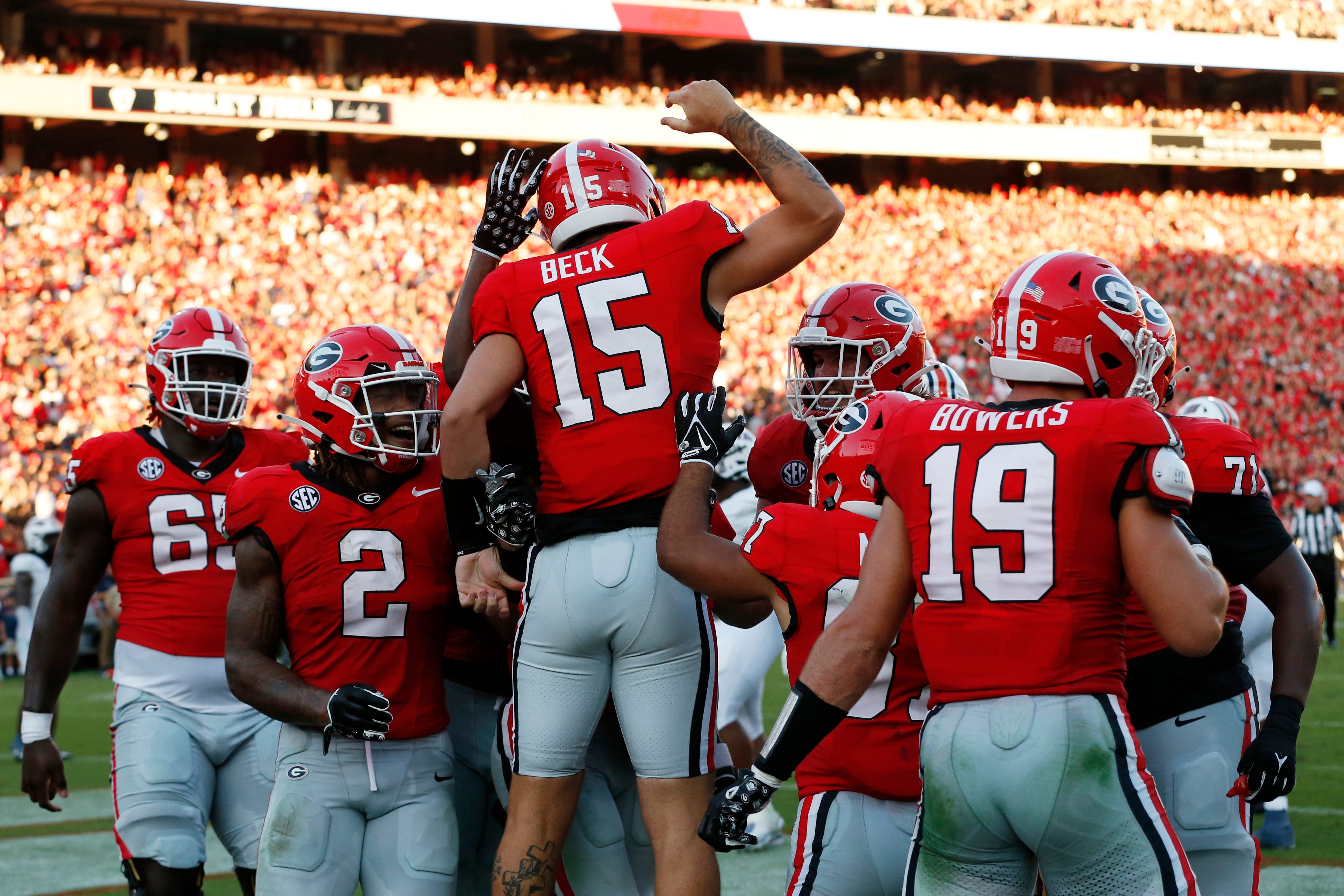 Georgia quarterback Carson Beck celebrates with his teammates after scoring a touchdown during the first half of a game against UT Martin. Beck leads the 2024 Heisman Trophy Odds.