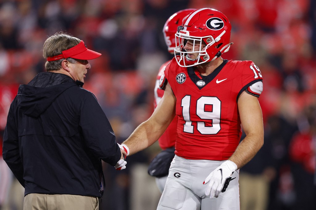 Head coach Kirby Smart of the Georgia Bulldogs speaks with Brock Bowers prior to the game as we share our best Week 14 expert picks.