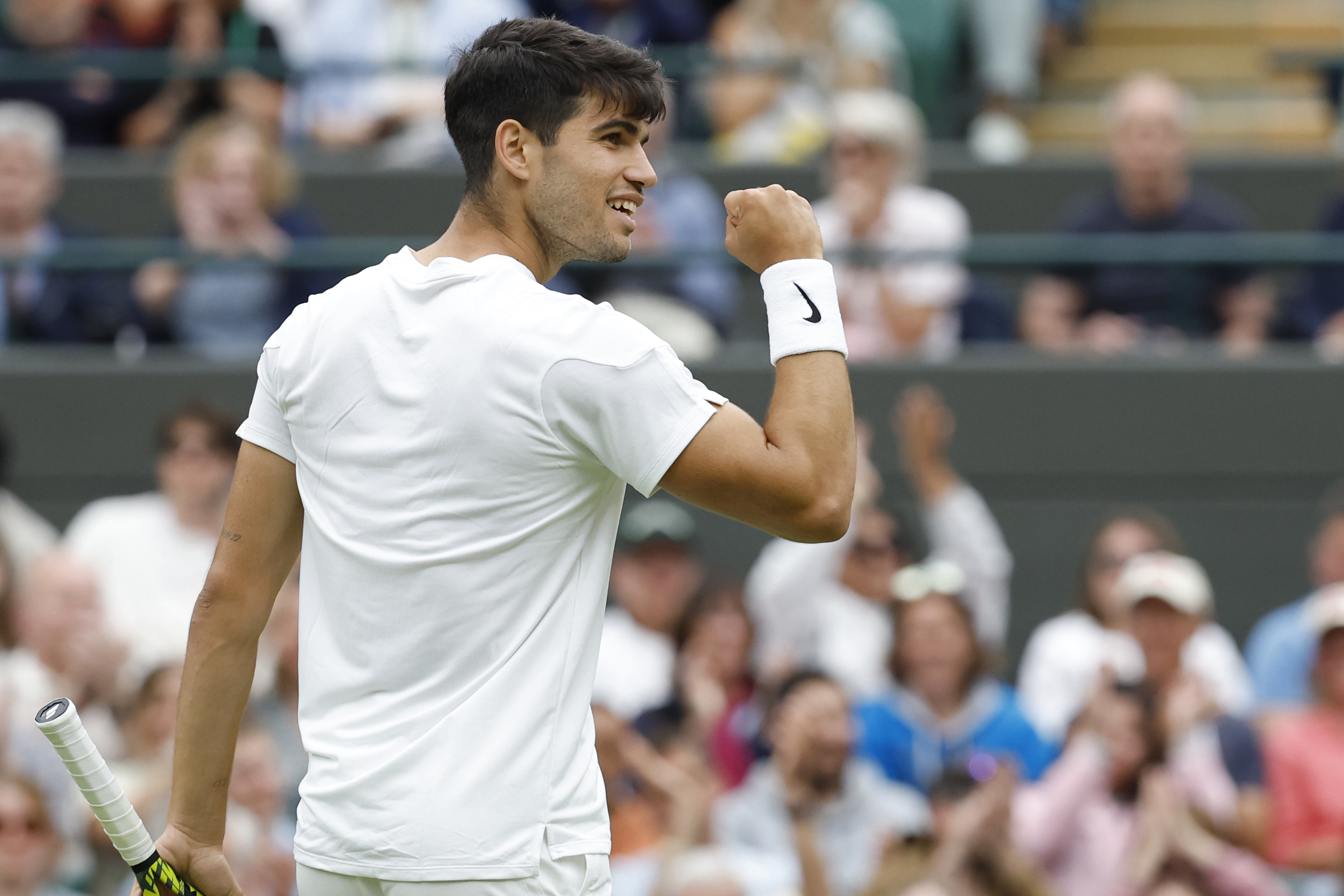 Carlos Alcaraz reacts after winning a point against Aleksandar Vukic as we provide the latest odds and predictions for Wimbledon 2024.