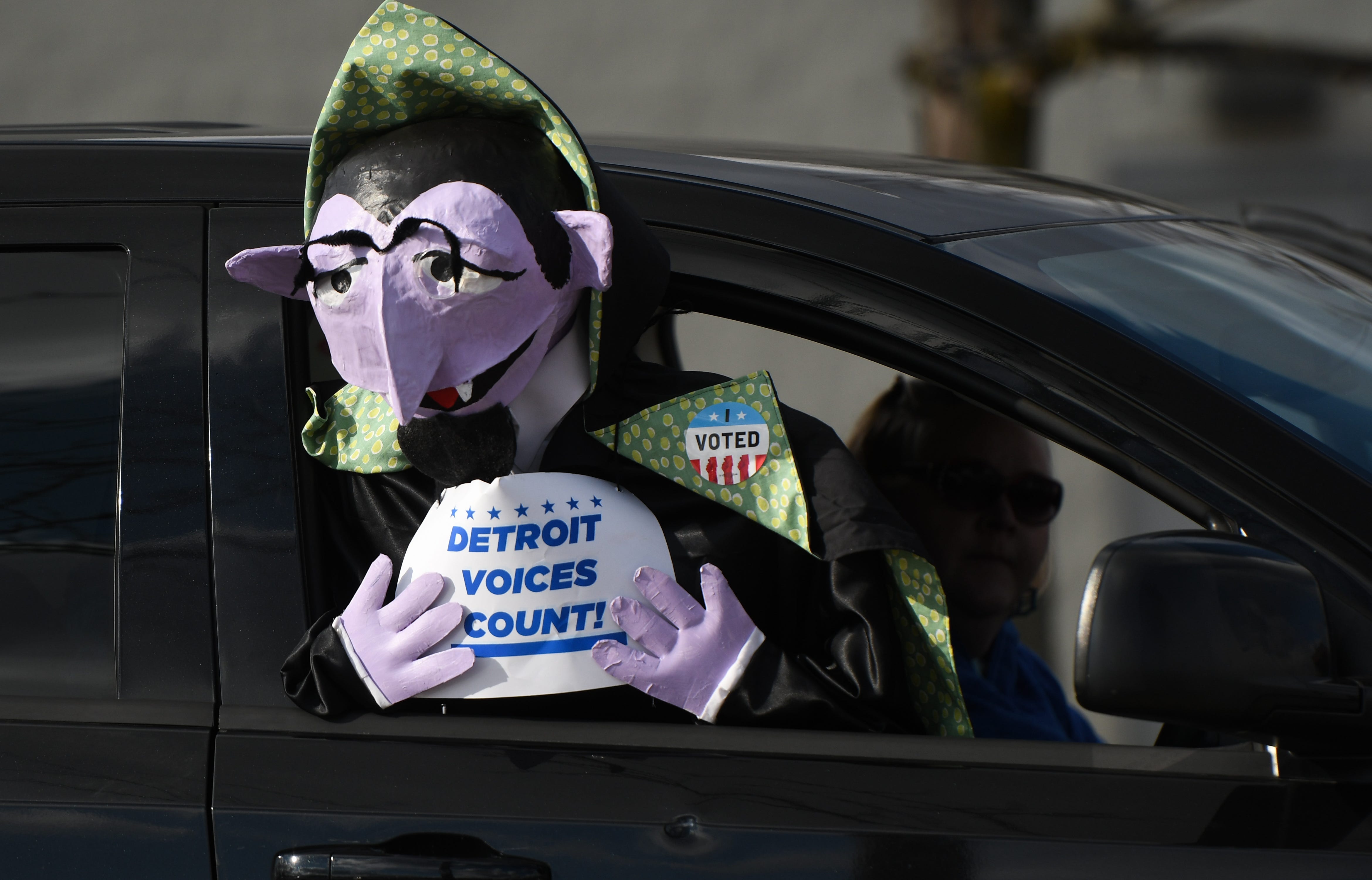 Demonstrators rally Monday, Nov. 23, 2020, as part of the the Driving for Democracy demonstration in Lansing 