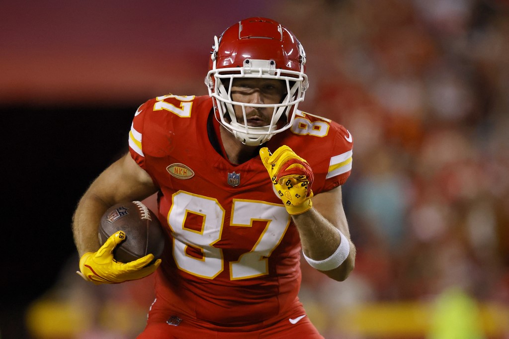Travis Kelce of the Kansas City Chiefs carries the ball as we share our favorite Travis Kelce player props.