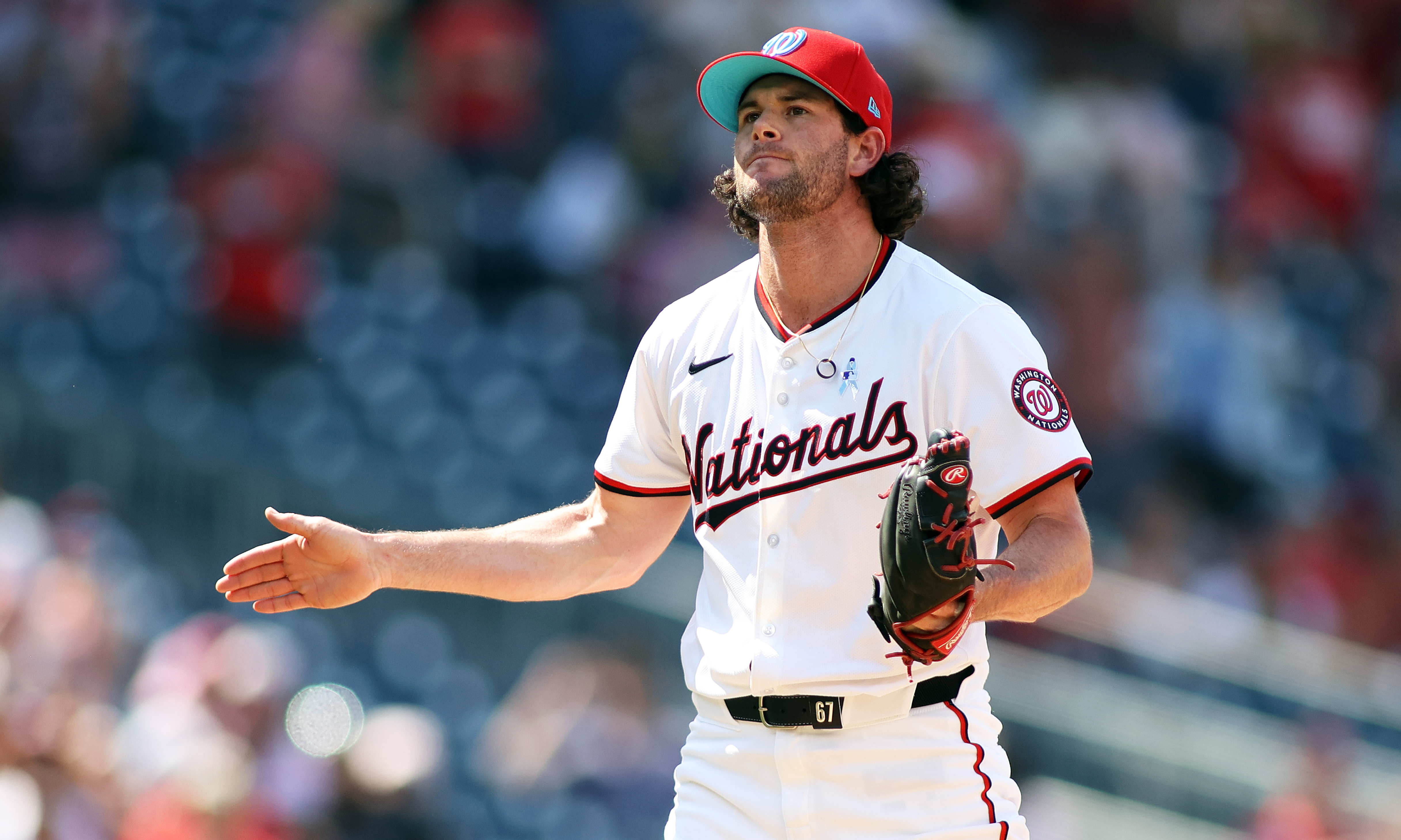 Washington Nationals pitcher Kyle Finnegan (67) celebrates after a game, as we explore FanDuel's potential termination of sports betting operations in Washington, D.C.