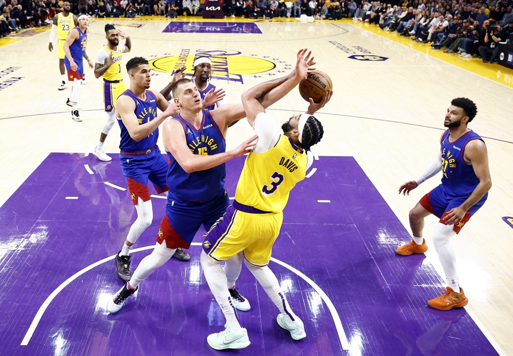 Anthony Davis of the Los Angeles Lakers takes a shot against Nikola Jokic of the Denver Nuggets in the first quarter during Game 3 of the Western Conference playoffs. We're backing Jokic in our Lakers vs. Nuggets player props.