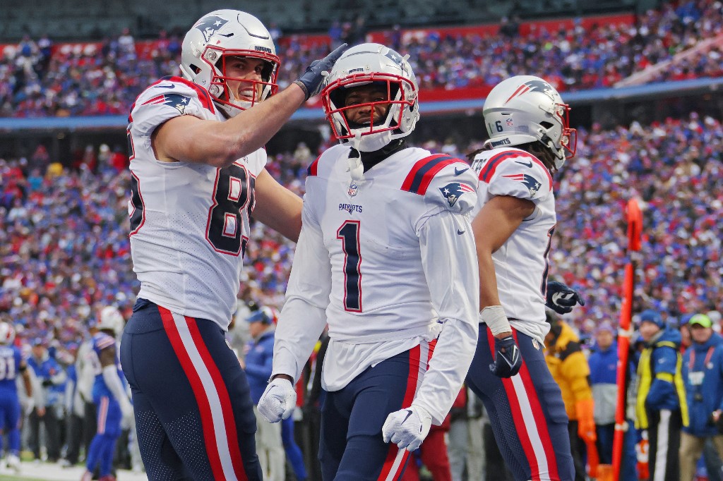 Hunter Henry of the New England Patriots celebrates with DeVante Parker, and NFL action played a big role in Maine's successful first full month of legal sports betting in December.
