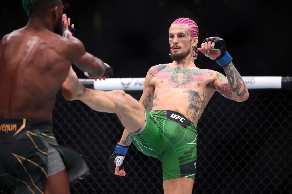 Sean O’Malley throws a kick against Aljamain Sterling during their Bantamweight title fight as we look at the best Fanatics promo code for UFC 299