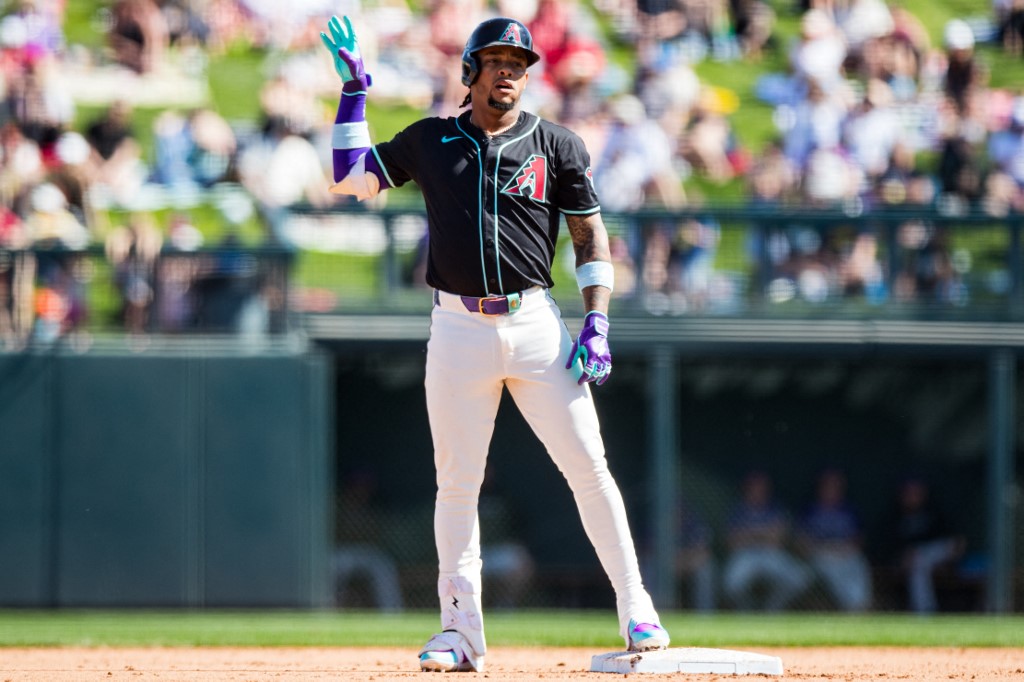 Ketel Marte #4 of the Arizona Diamondbacks gestures after hitting a double as we look at the details surrounding Fanatics Underscoreg launching in Arizona