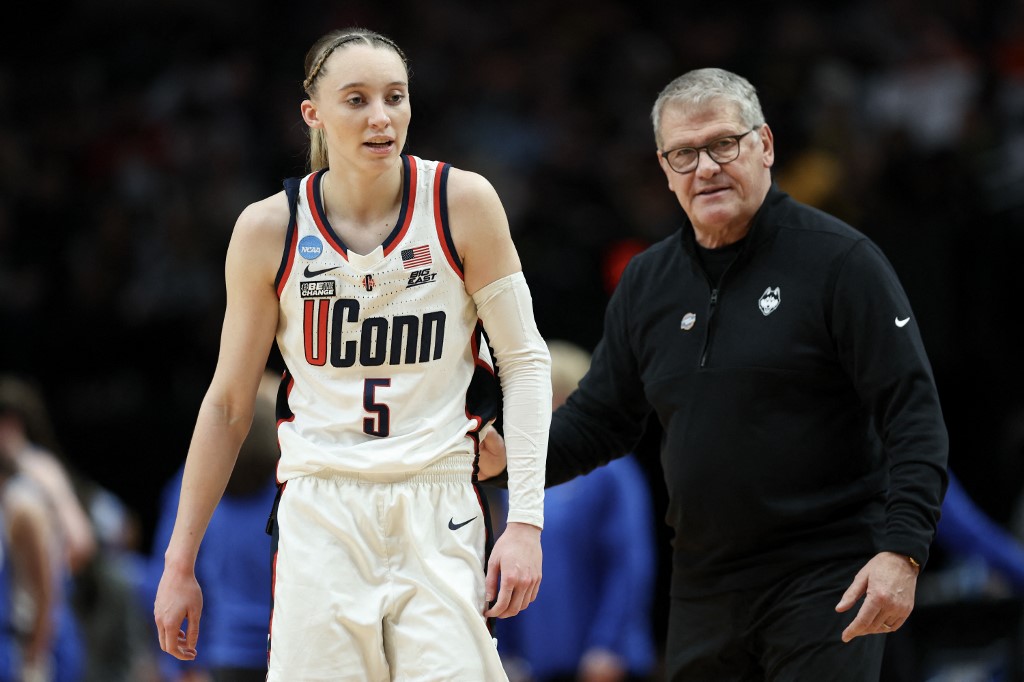 Paige Bueckers #5 to head coach Geno Auriemma of the Connecticut Huskies as we offer our UConn vs. USC prediction and pick for the Elite Eight of the women's NCAA Tournament on Monday at the Moda Center in Portland, Ore.