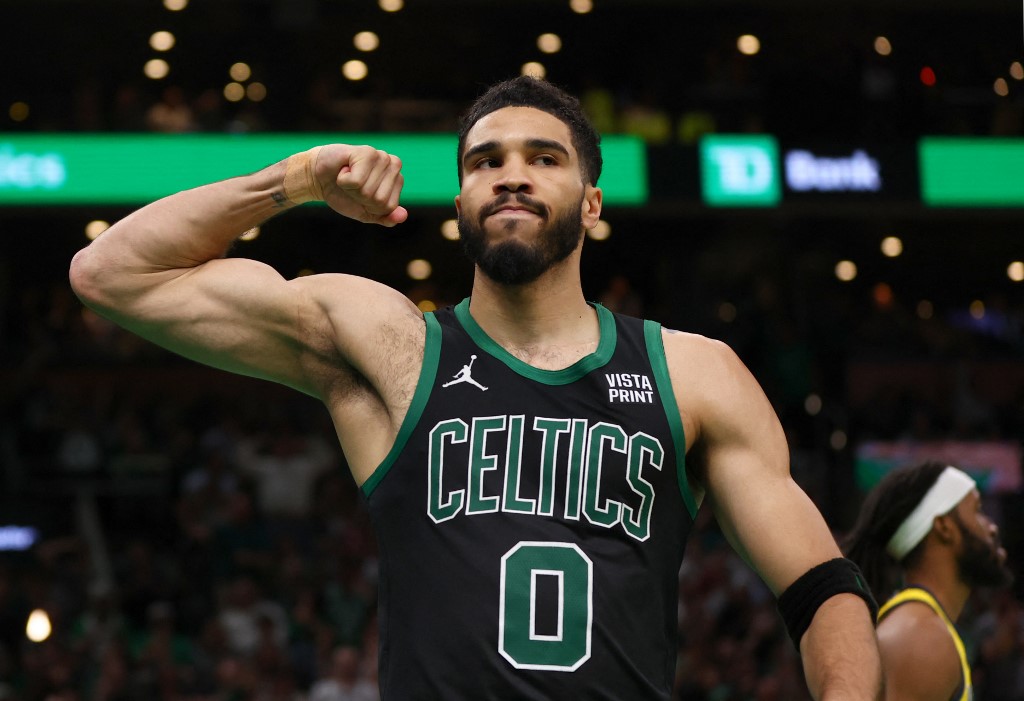 Boston Celtics forward Jayson Tatum flexes his right arm on the court as we look at our NBA Finals MVP odds and predictions.