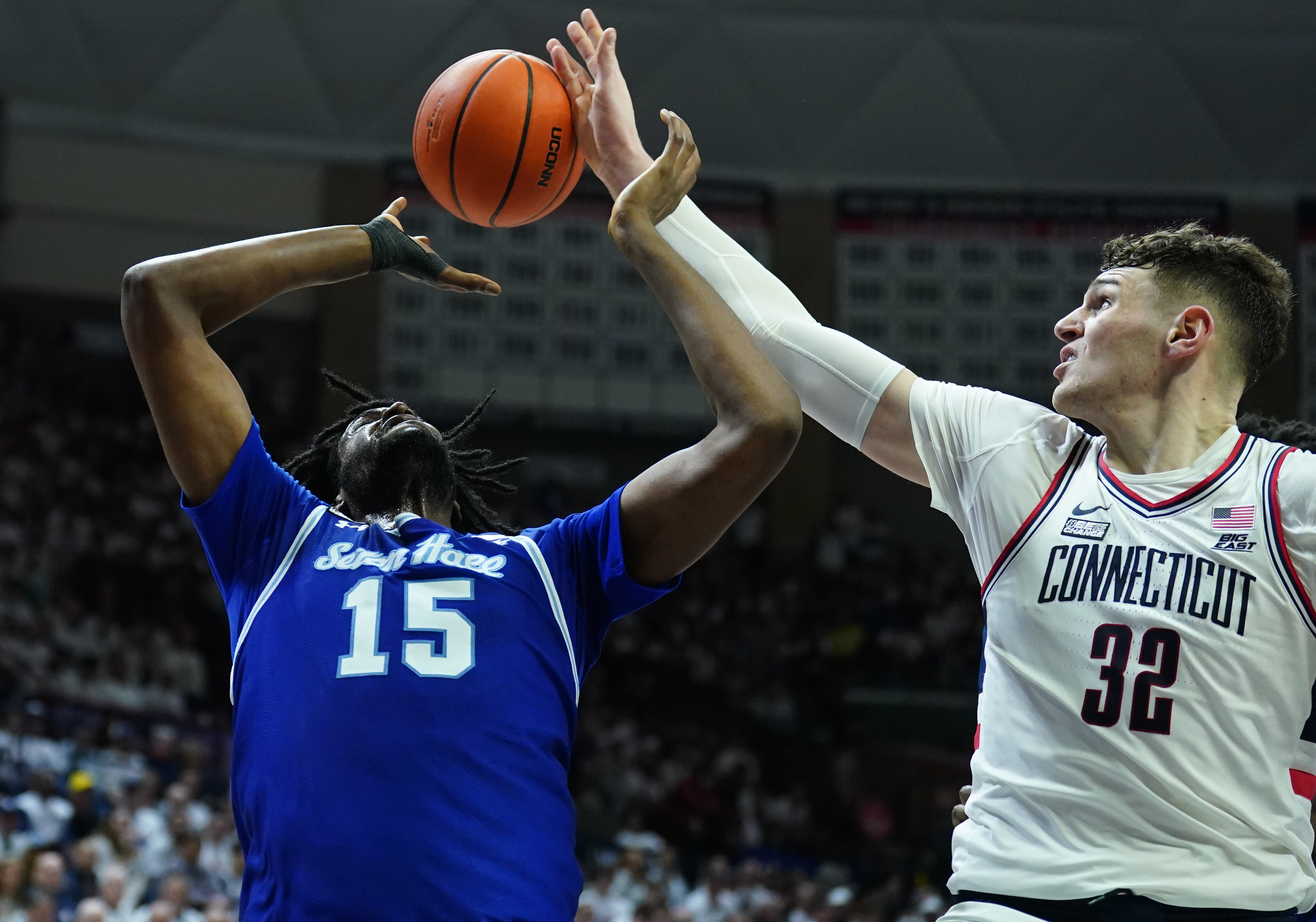 UConn Huskies center Donovan Clingan (32) blocks the shot of Seton Hall Pirates center Jaden Bediako (15), as we examine Connecticut banning Bovada.